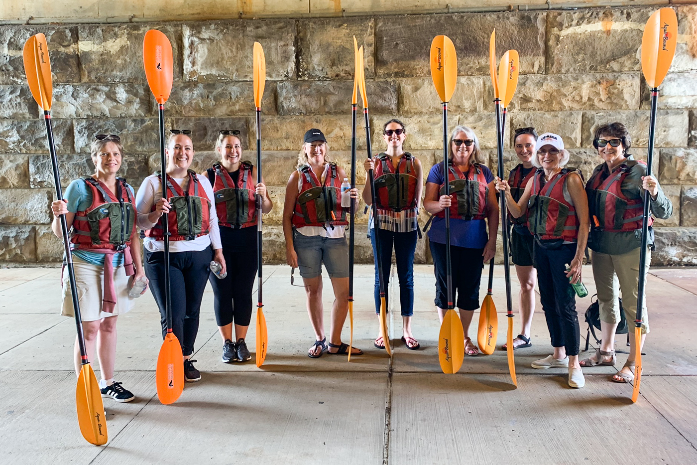 Women of Impact members prepare to embark on a kayaking session.
