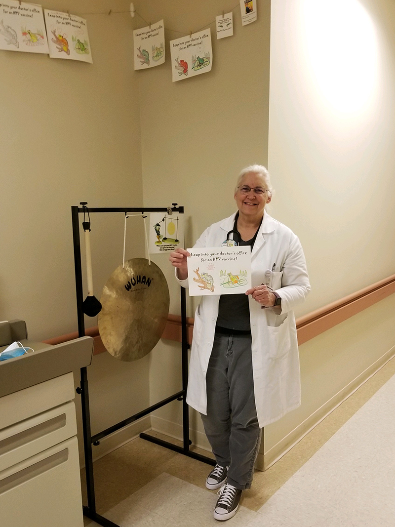 Dr. McGaffey with the Health Center gong and a submitted coloring page
